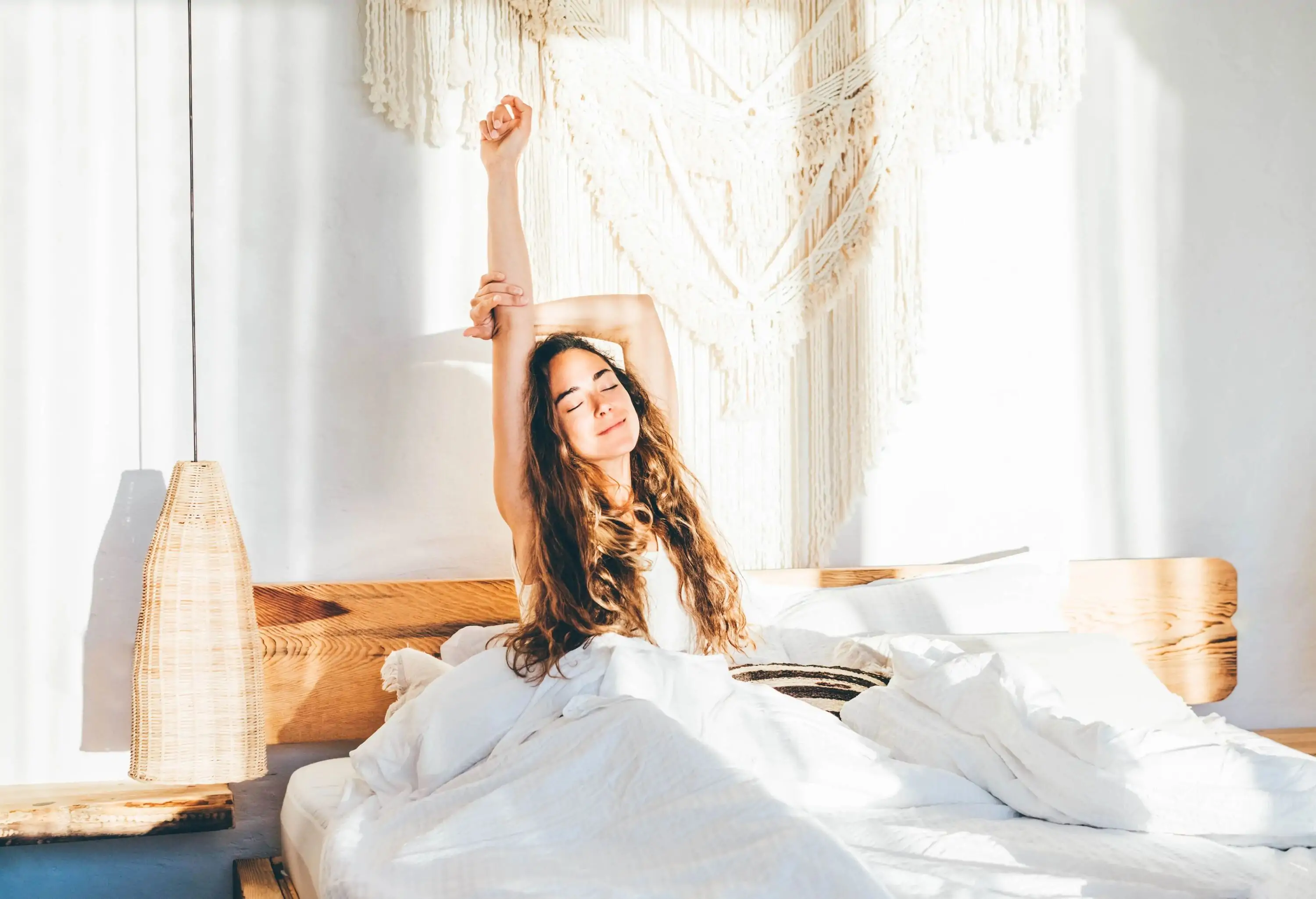 woman stretching on hotel bed